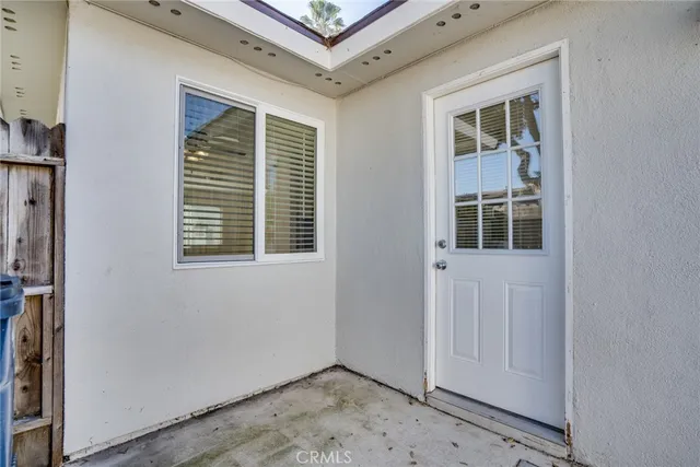 a view of an empty room with a window and workspace