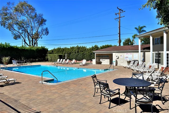 a view of a swimming pool with a table and chairs