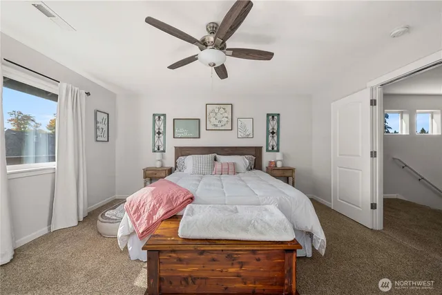 a bedroom with a bed and a chandelier