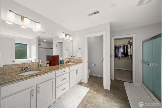 a spacious bathroom with a granite countertop sink mirror and a