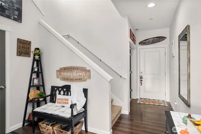 a view of a hallway with furniture and entryway