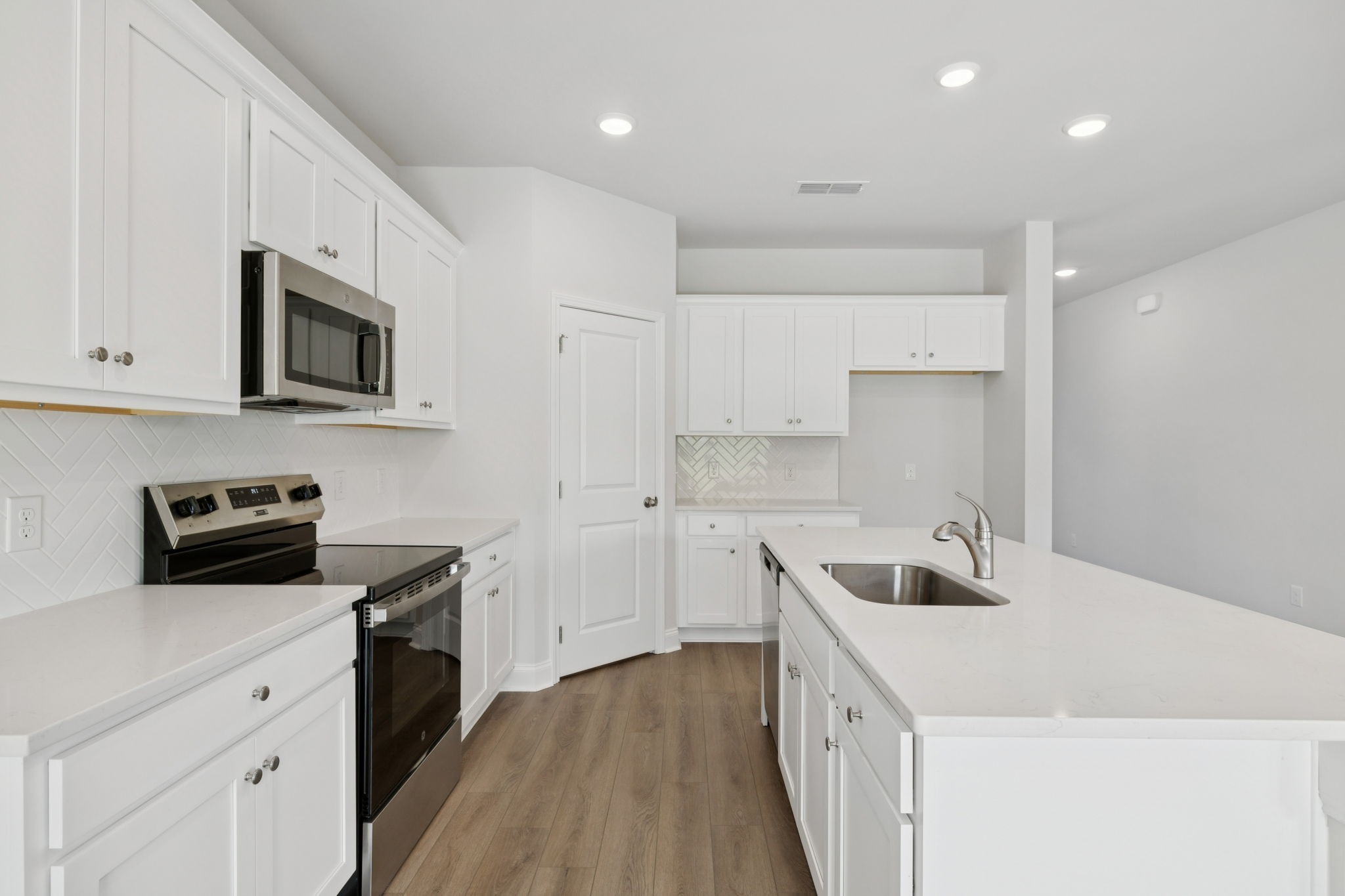 228 Limestone Way Lebanon, TN 37087 - Photo 12 of 45 a kitchen with a sink stove top oven and cabinets