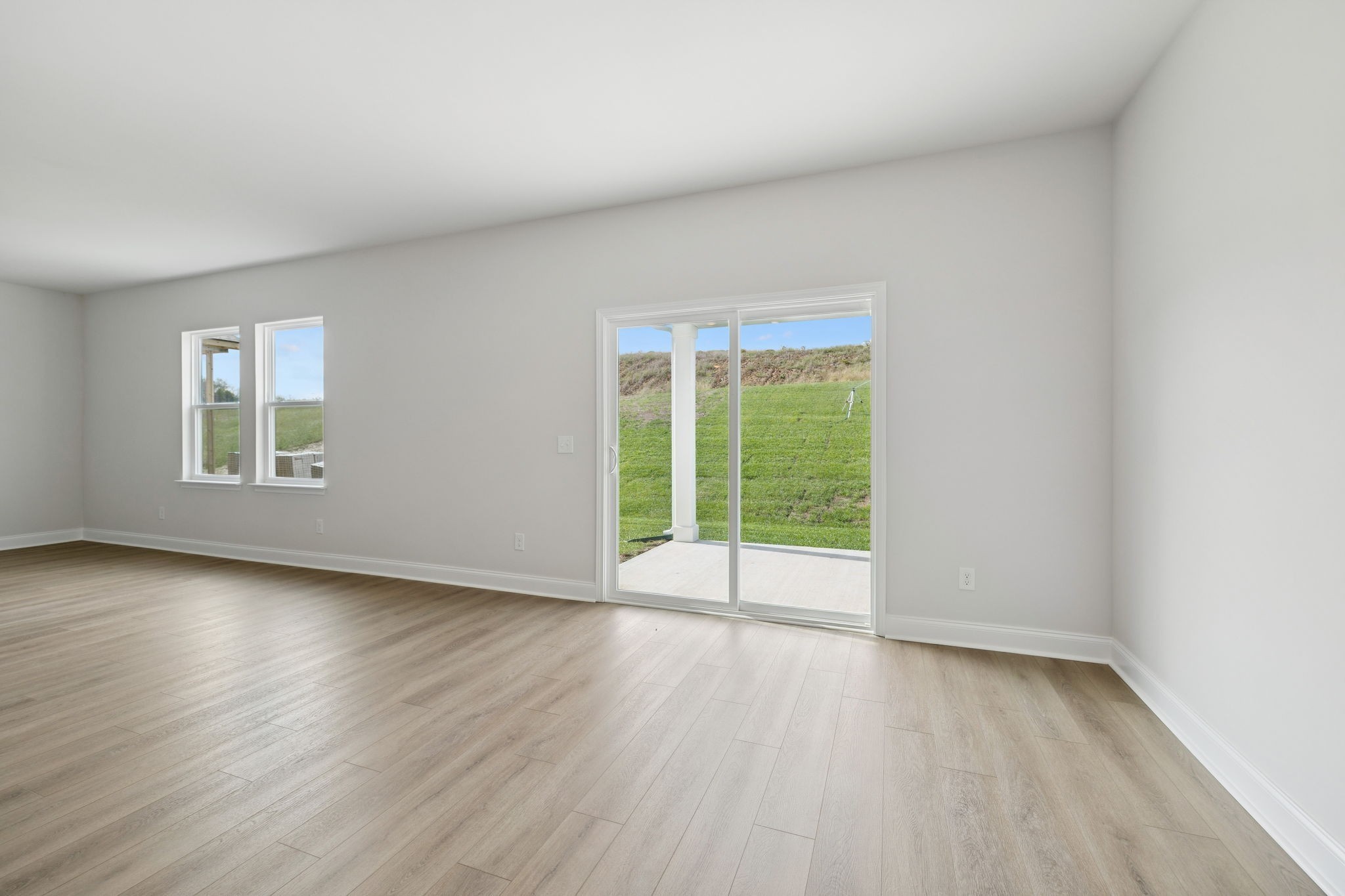 228 Limestone Way Lebanon, TN 37087 - Photo 15 of 45 an empty room with wooden floor and windows