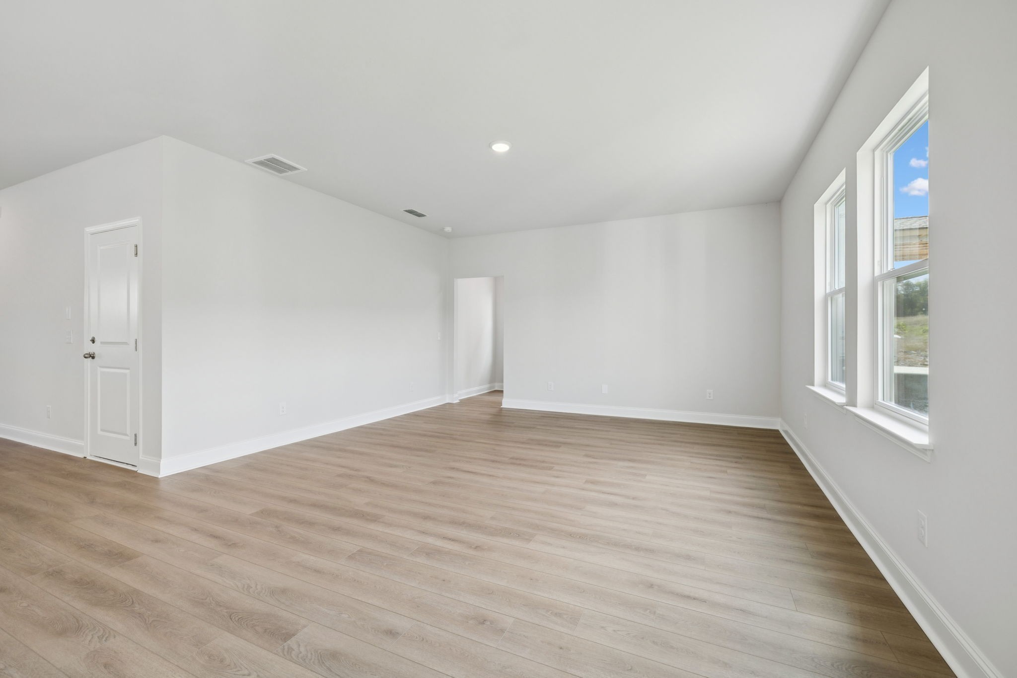 228 Limestone Way Lebanon, TN 37087 - Photo 17 of 45 a view of an empty room with wooden floor and a window