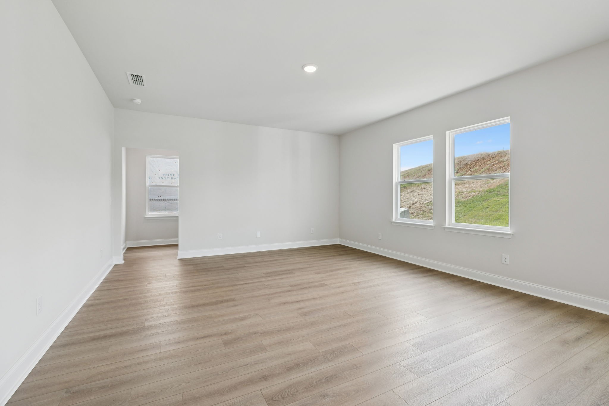 228 Limestone Way Lebanon, TN 37087 - Photo 18 of 45 an empty room with wooden floor and windows