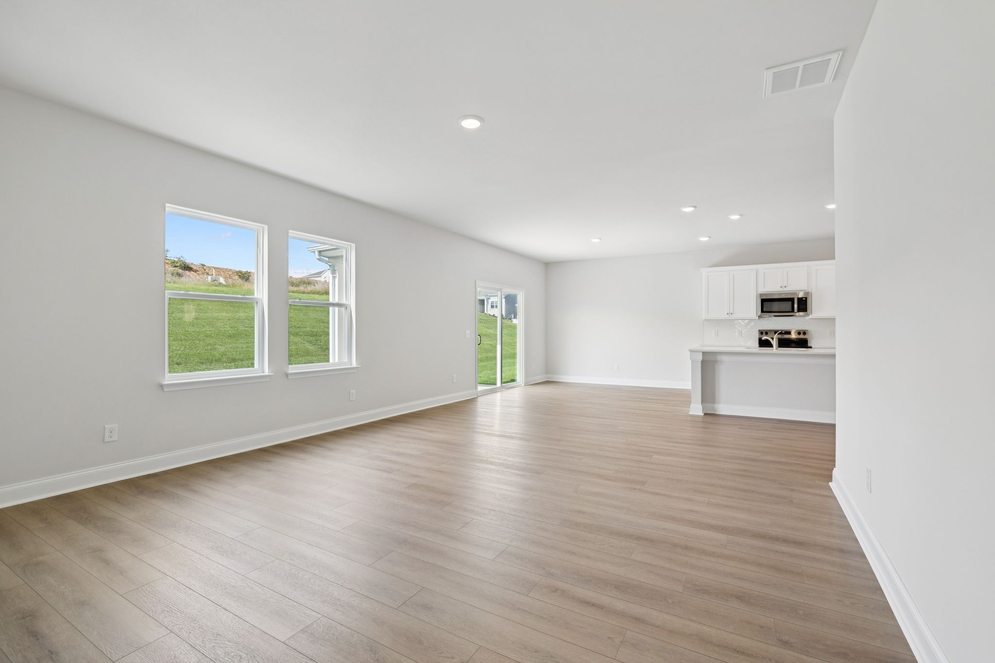 228 Limestone Way Lebanon, TN 37087 - Photo 19 of 45 an empty room with wooden floor and windows