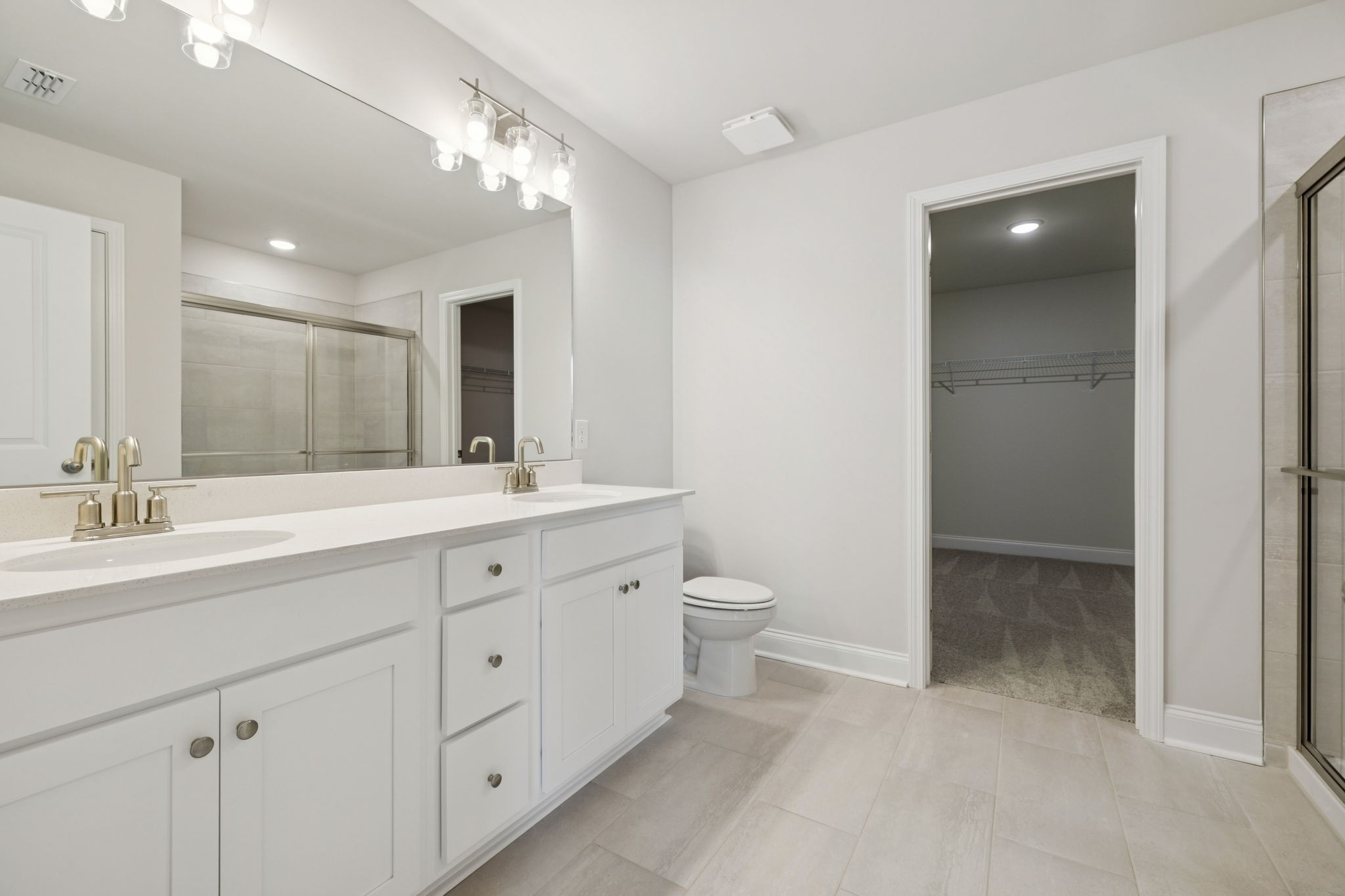 228 Limestone Way Lebanon, TN 37087 - Photo 25 of 45 a spacious bathroom with a double vanity sink a toilet and a large mirror