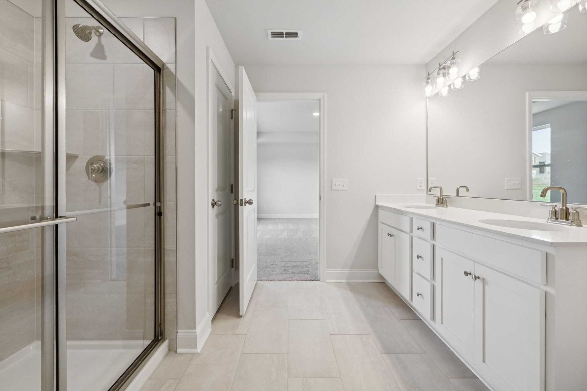 228 Limestone Way Lebanon, TN 37087 - Photo 26 of 45 a bathroom with a double vanity sink a toilet and shower