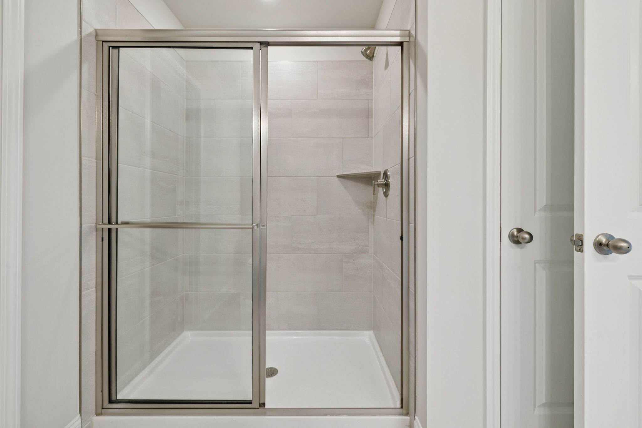 228 Limestone Way Lebanon, TN 37087 - Photo 27 of 45 a bathroom with a glass shower door