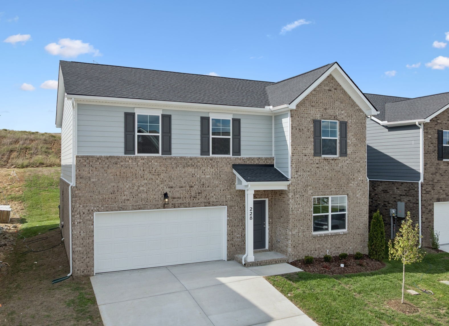 228 Limestone Way Lebanon, TN 37087 - Photo 3 of 45 a front view of a house with a yard and garage