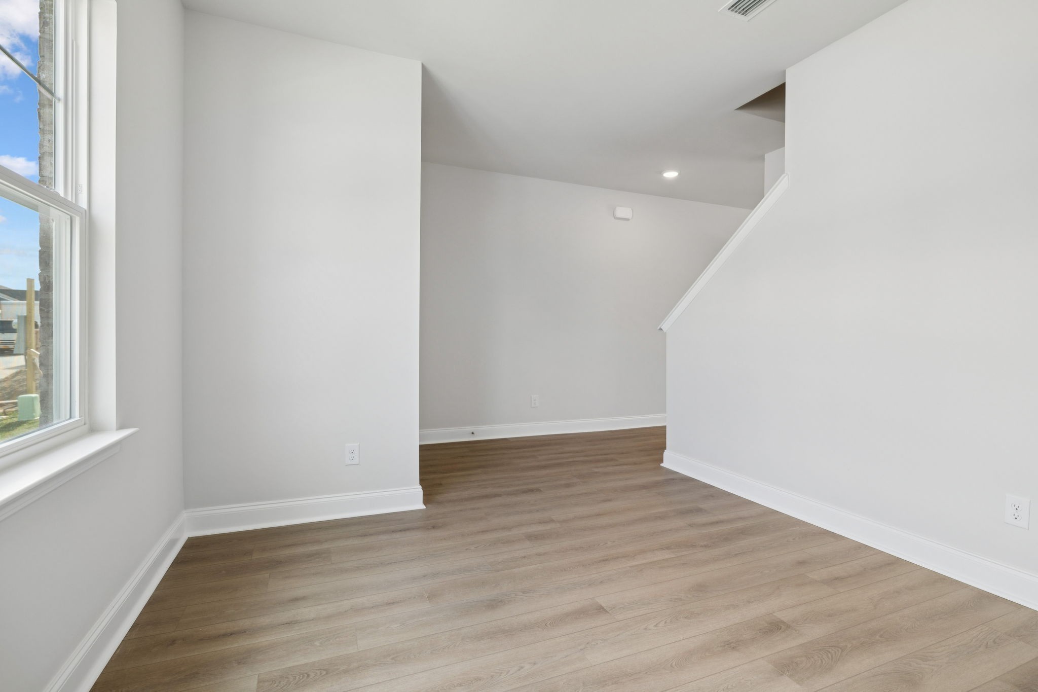 228 Limestone Way Lebanon, TN 37087 - Photo 8 of 45 a view of an empty room with wooden floor and a window