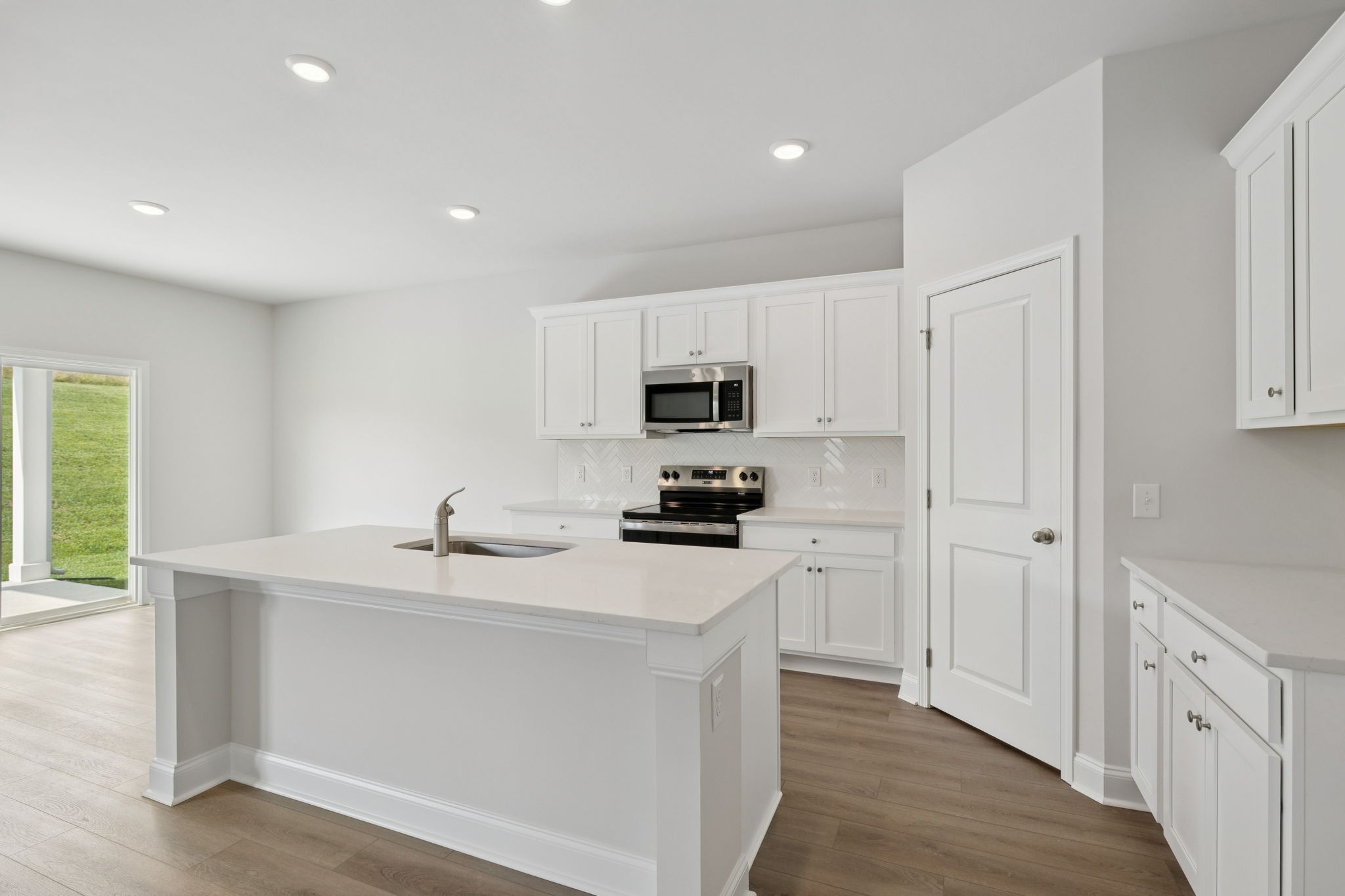 228 Limestone Way Lebanon, TN 37087 - Photo 9 of 45 a kitchen with white cabinets and stainless steel appliances
