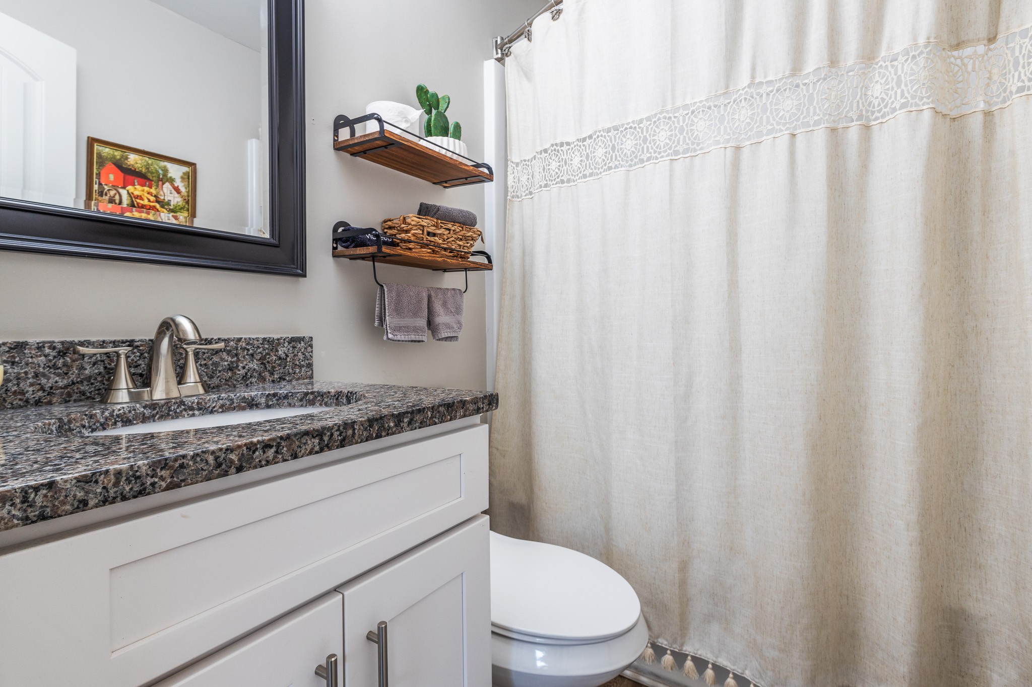 404 Elm Street Madison, TN 37115 - Photo 16 of 28 a bathroom with a sink a toilet and a shower curtain