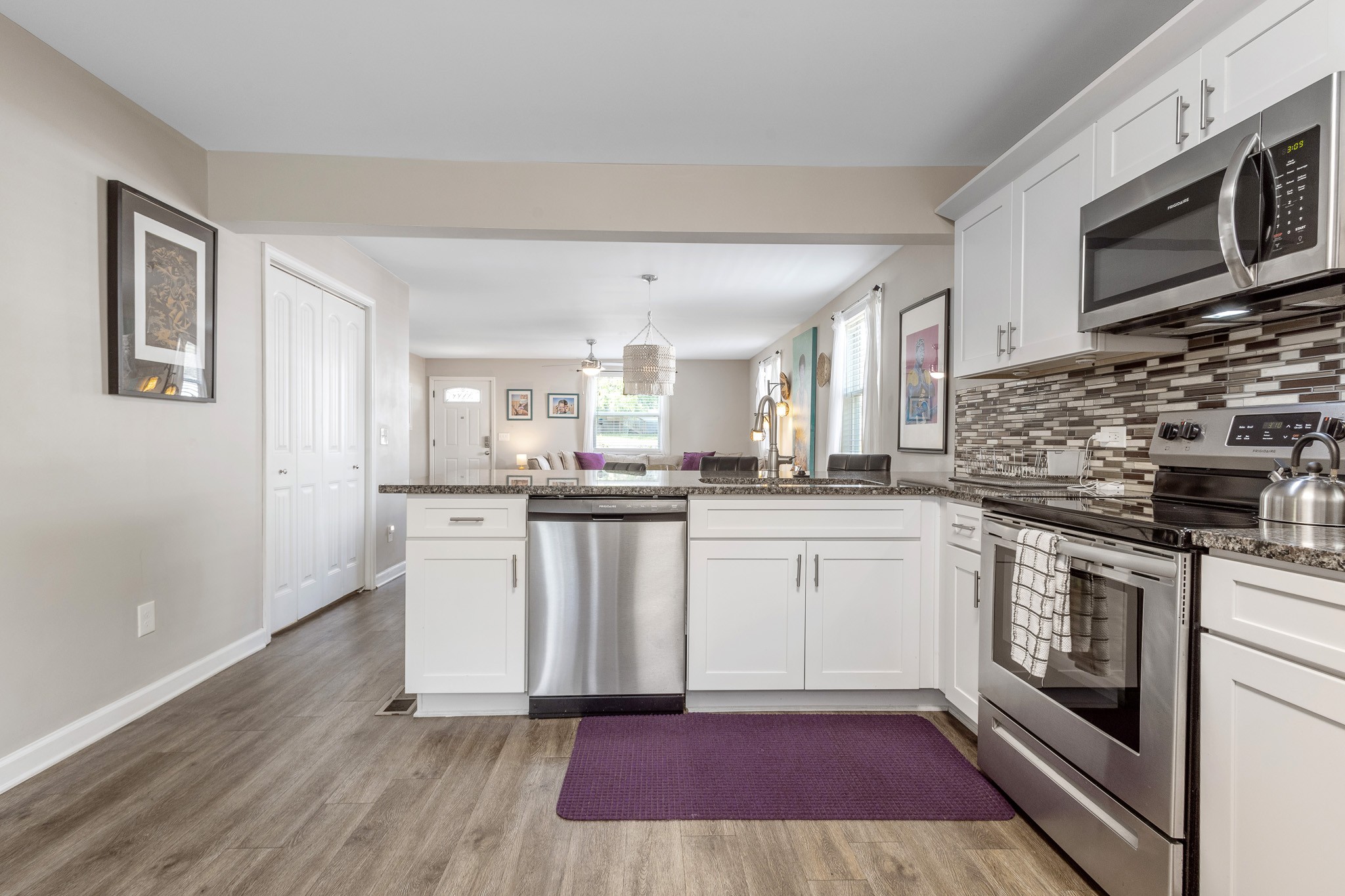 404 Elm Street Madison, TN 37115 - Photo 8 of 28 a kitchen with stainless steel appliances kitchen island granite countertop a stove a sink and a microwave