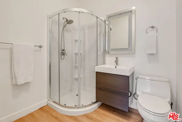 a bathroom with a shower a toilet and a sink