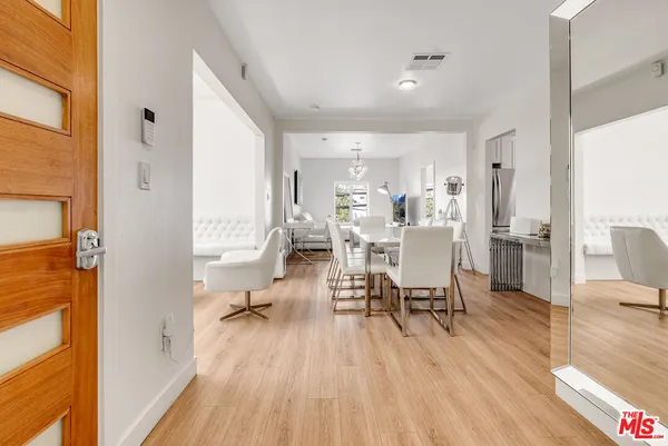 a living room with dining room and wooden floor