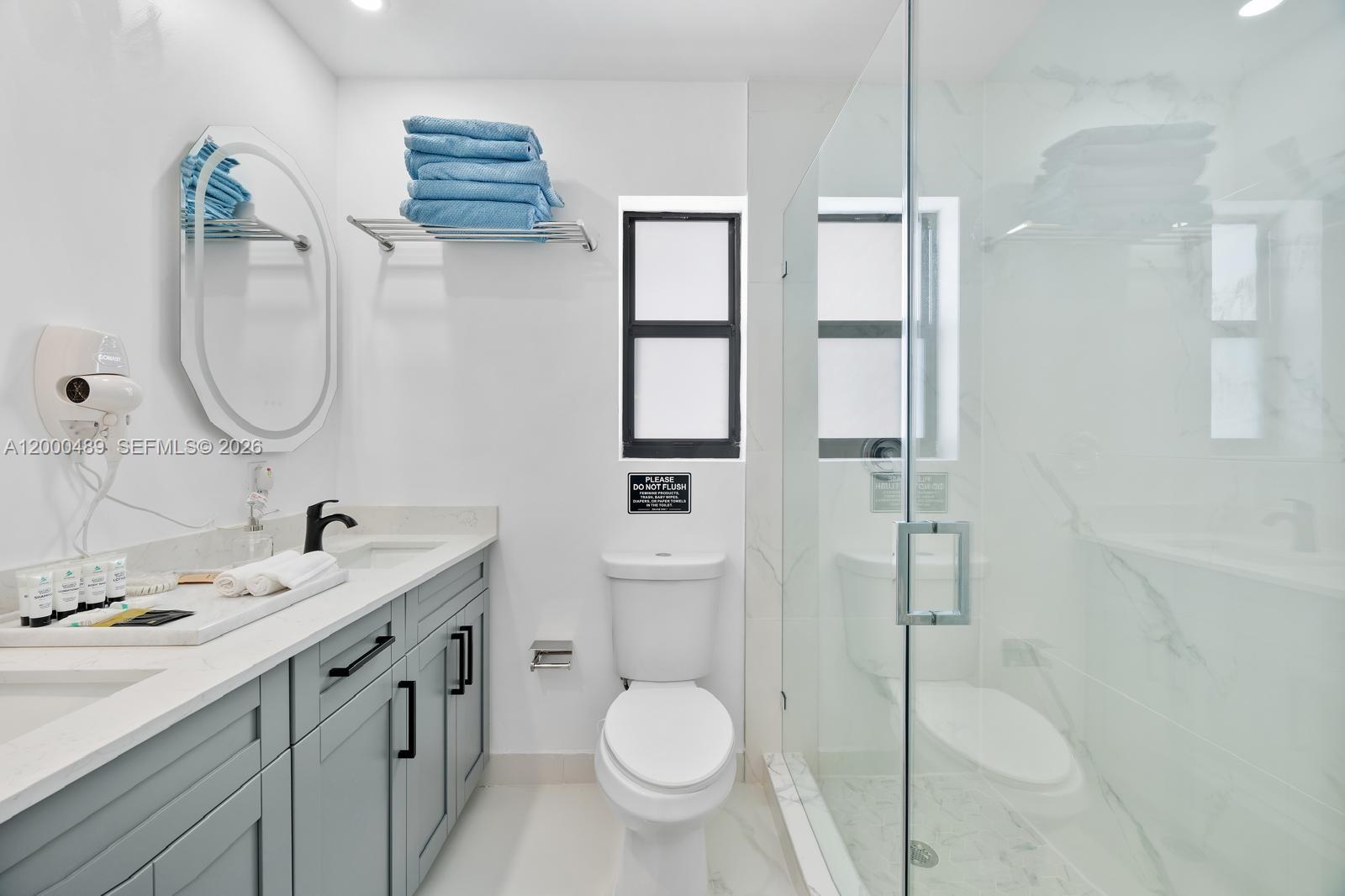 11730 Northwest 3rd Avenue Miami, FL 33168 - Photo 13 of 39 a bathroom with a toilet sink and mirror