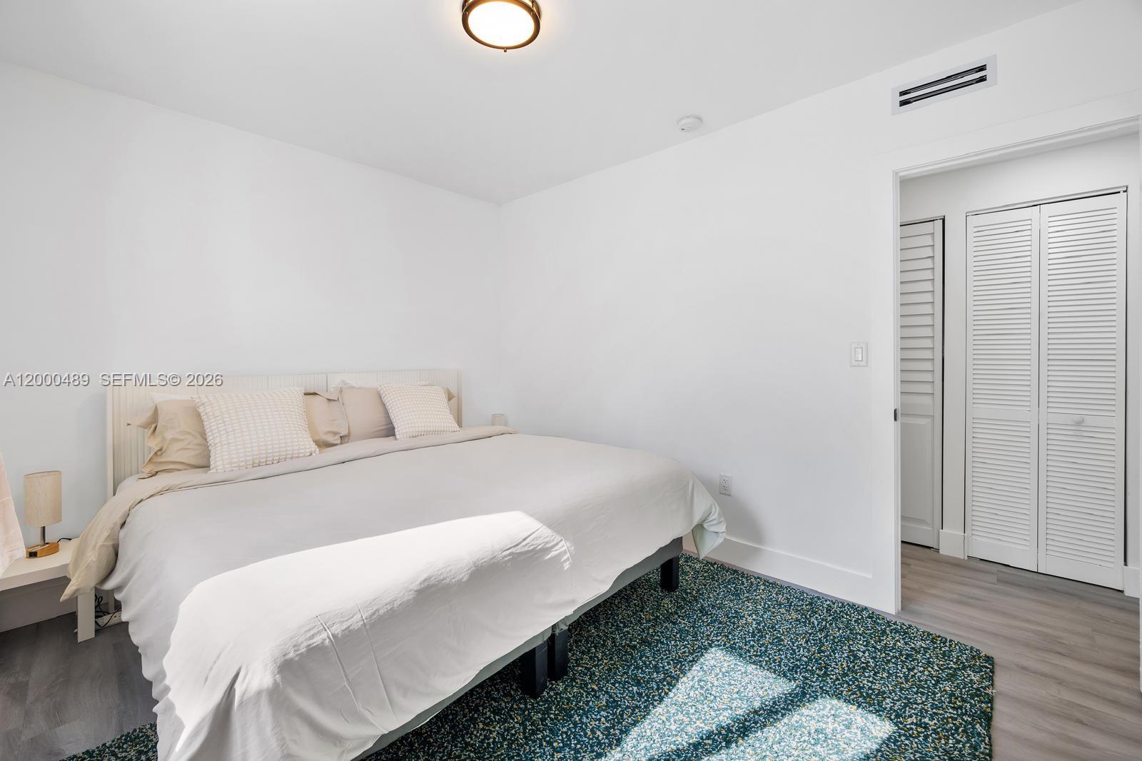 11730 Northwest 3rd Avenue Miami, FL 33168 - Photo 16 of 39 a bedroom with a bed and a rug
