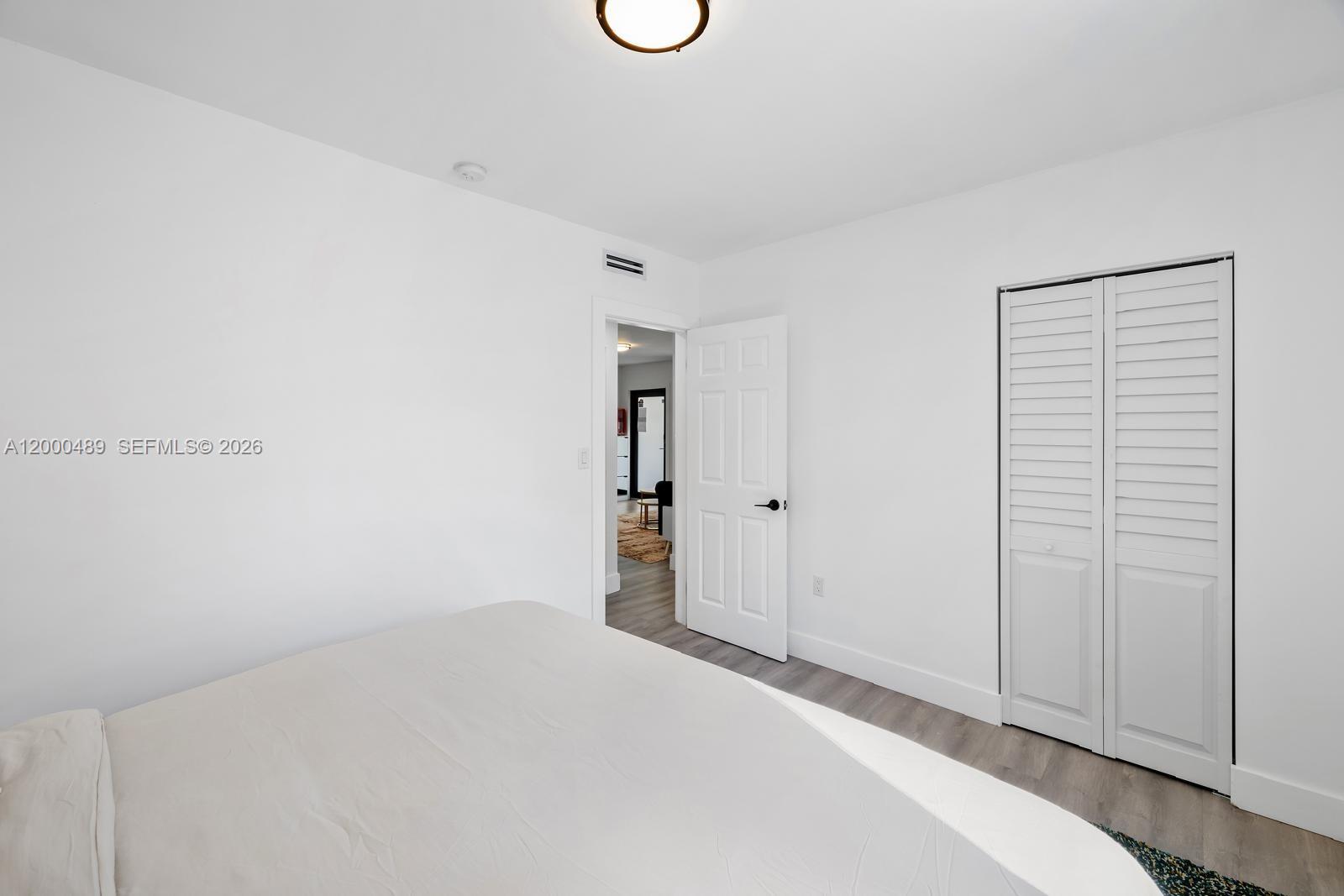 11730 Northwest 3rd Avenue Miami, FL 33168 - Photo 17 of 39 a bedroom with a bed and a window