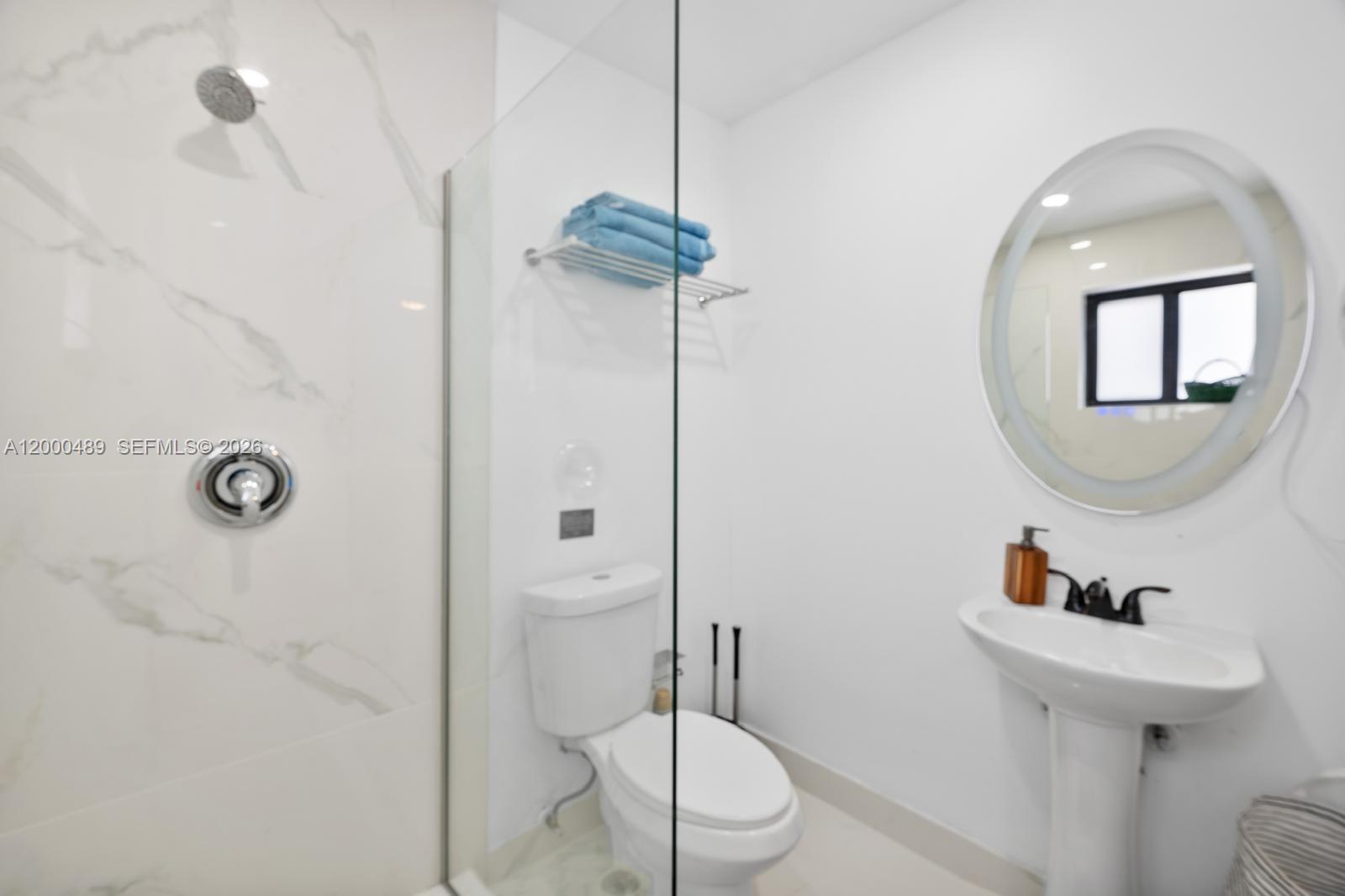 11730 Northwest 3rd Avenue Miami, FL 33168 - Photo 18 of 39 a bathroom with a toilet sink and mirror