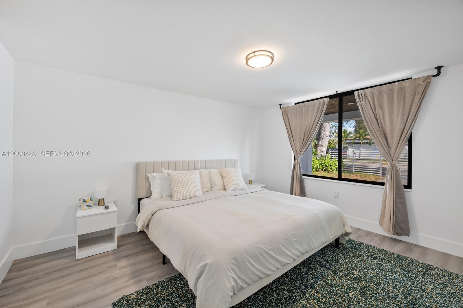 11730 Northwest 3rd Avenue Miami, FL 33168 - Photo 19 of 39 a bedroom with a bed and a window
