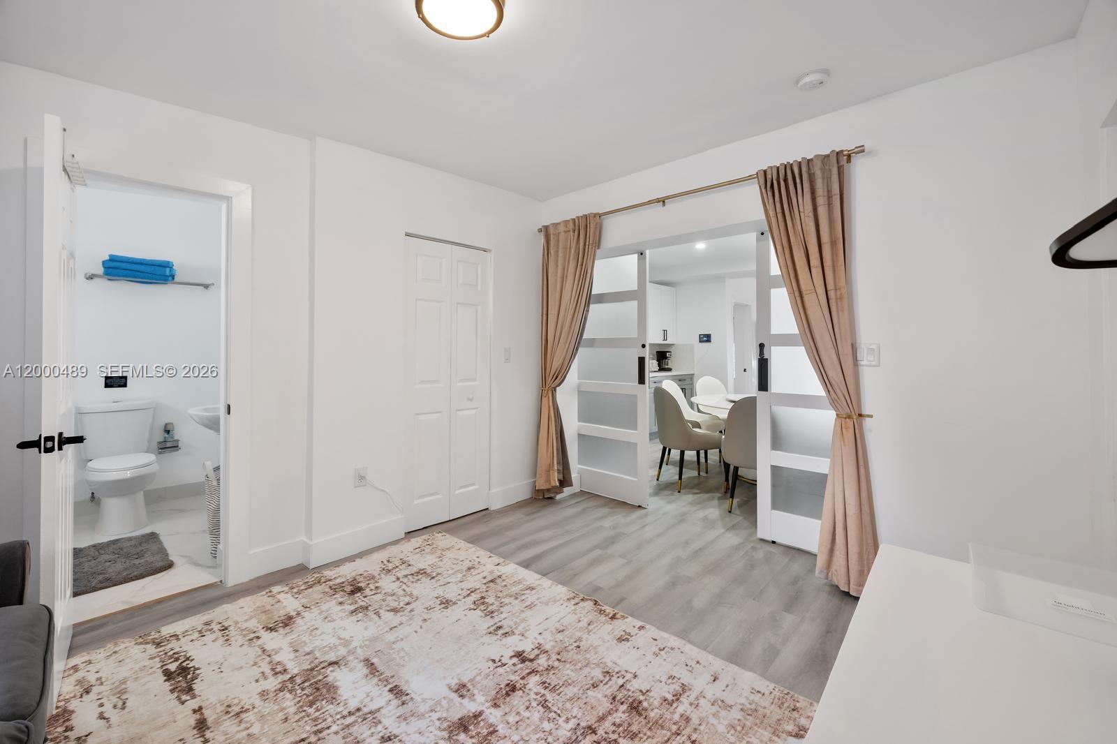 11730 Northwest 3rd Avenue Miami, FL 33168 - Photo 25 of 39 a bedroom with a bed and a view of bathroom