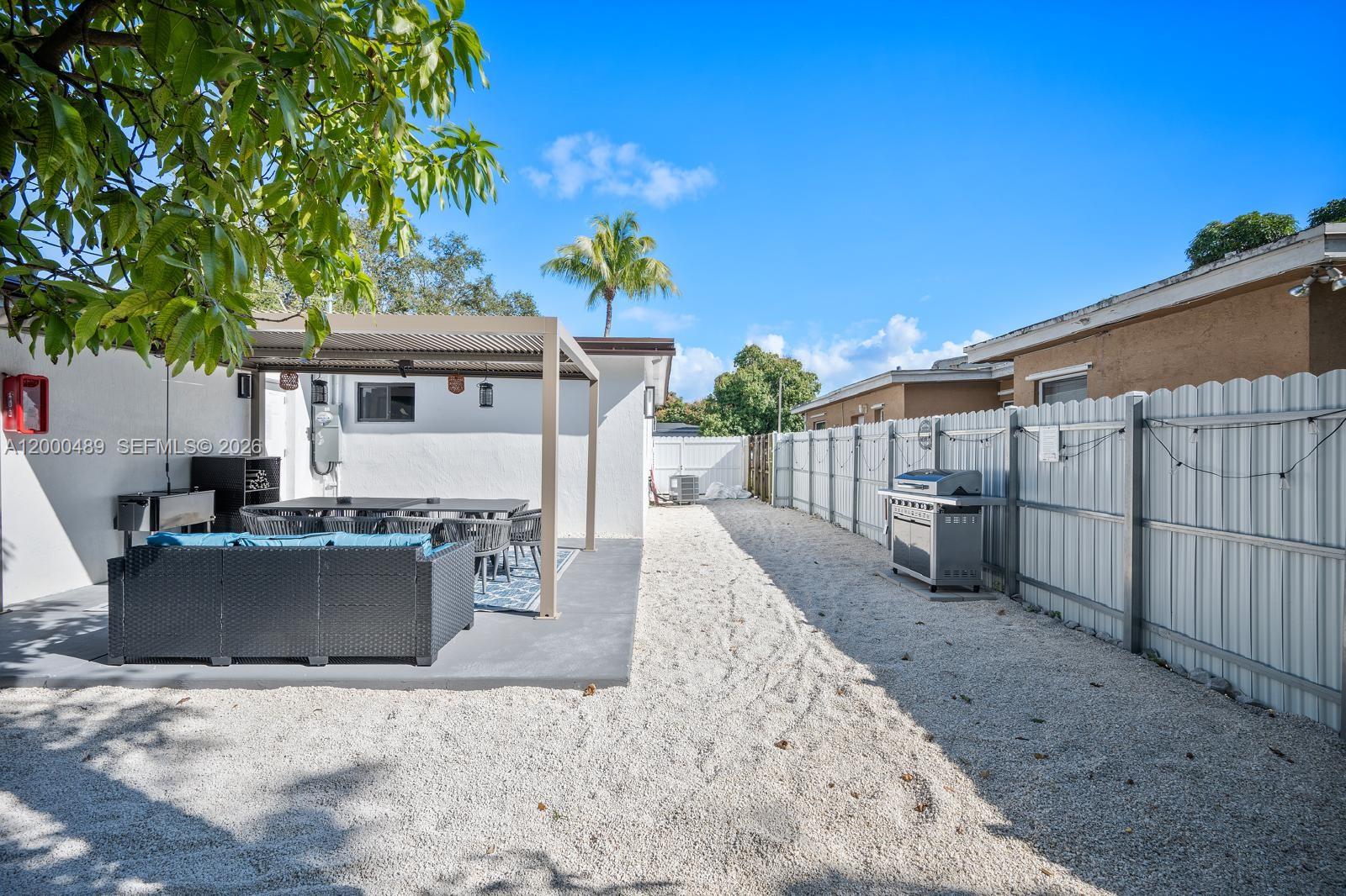 11730 Northwest 3rd Avenue Miami, FL 33168 - Photo 34 of 39 a view of a house with backyard and sitting area