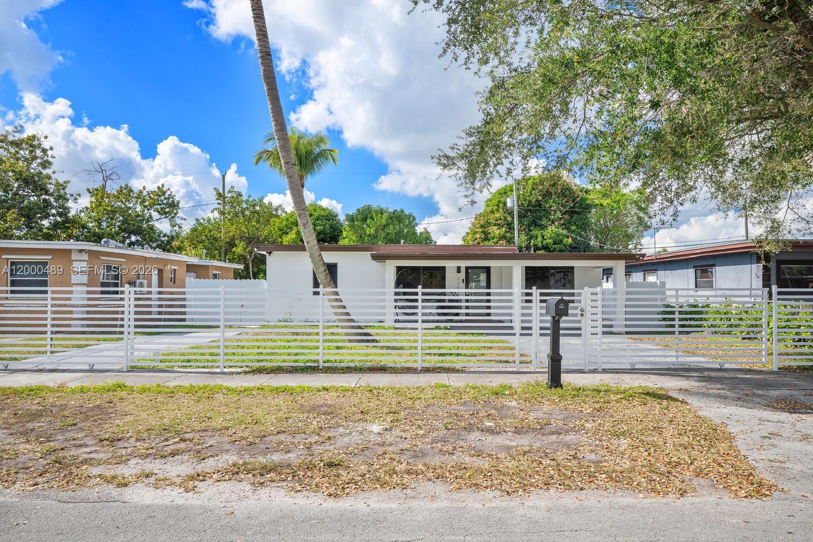 11730 Northwest 3rd Avenue Miami, FL 33168 - Photo 39 of 39 a front view of a house with a yard