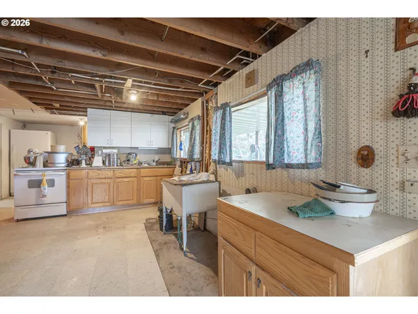 a kitchen with a sink cabinets and wooden floor