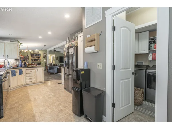 a kitchen with stainless steel appliances kitchen island granite countertop a refrigerator and a sink