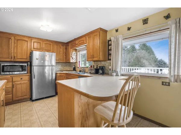 a kitchen with refrigerator and window