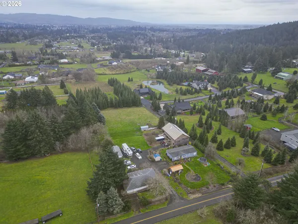 an aerial view of a houses with a yard