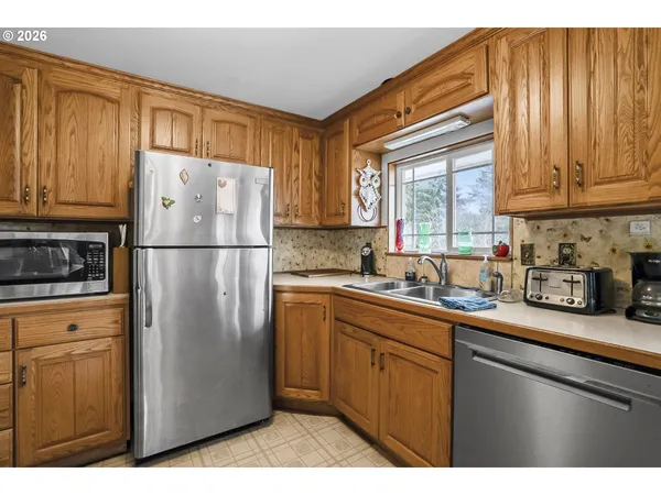 a kitchen with stainless steel appliances granite countertop a refrigerator sink and cabinets