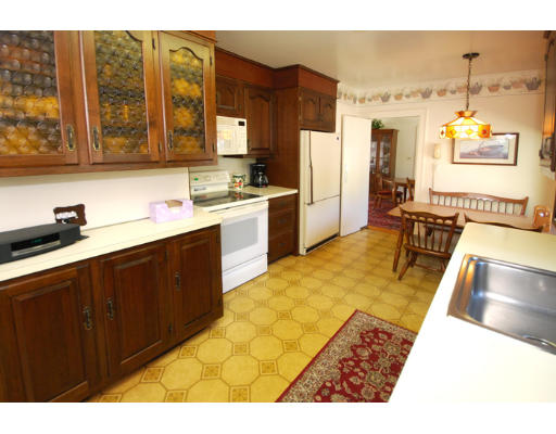 20 Mansfield Road Wellesley, MA 02481 - Photo 12 of 14 a kitchen with stainless steel appliances granite countertop a sink stove and refrigerator