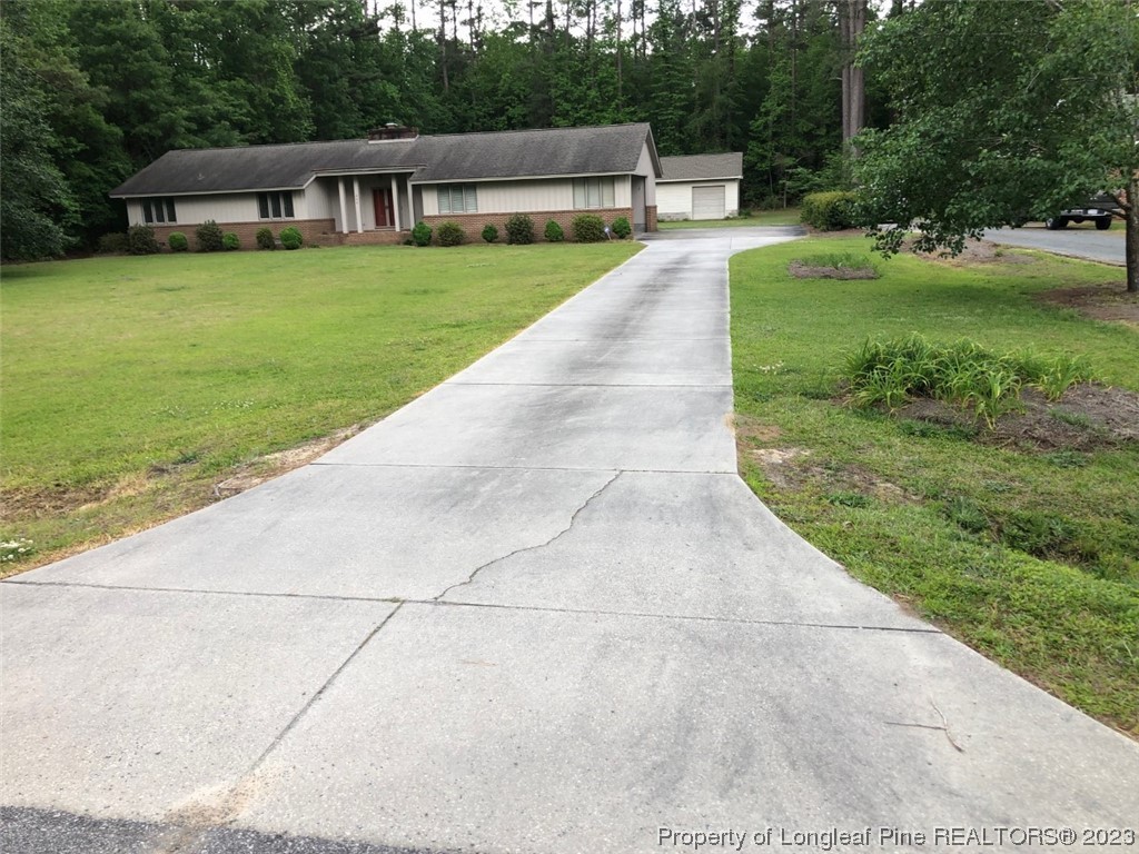 846 Bee Gee Road Lumberton, NC 28358 - Photo 16 of 42 a house view with a sitting space and garden