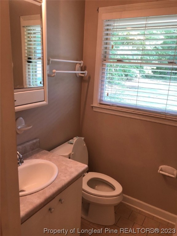 846 Bee Gee Road Lumberton, NC 28358 - Photo 33 of 42 a bathroom with a toilet a sink and a window