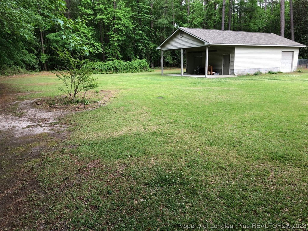 846 Bee Gee Road Lumberton, NC 28358 - Photo 10 of 42 a front view of a house with a yard and trees