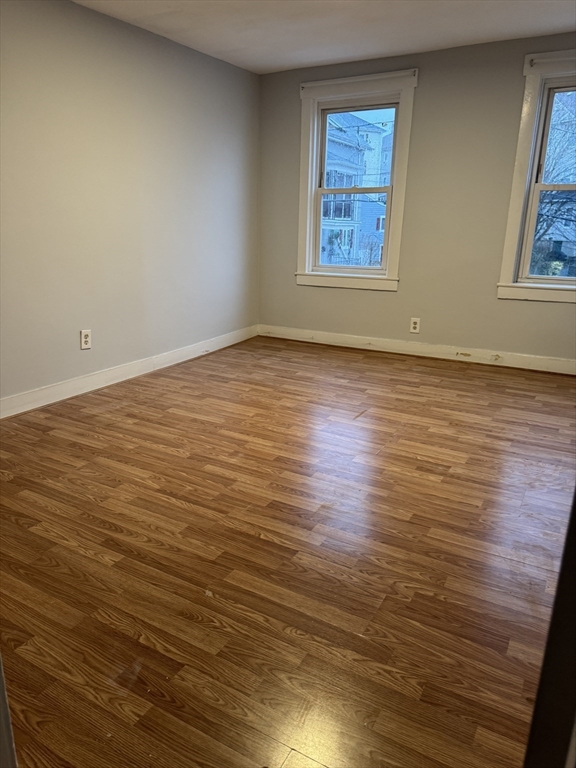 93 Webster Street, Unit 2 Fall River, MA 02723 - Photo 9 of 15 wooden floor in an empty room