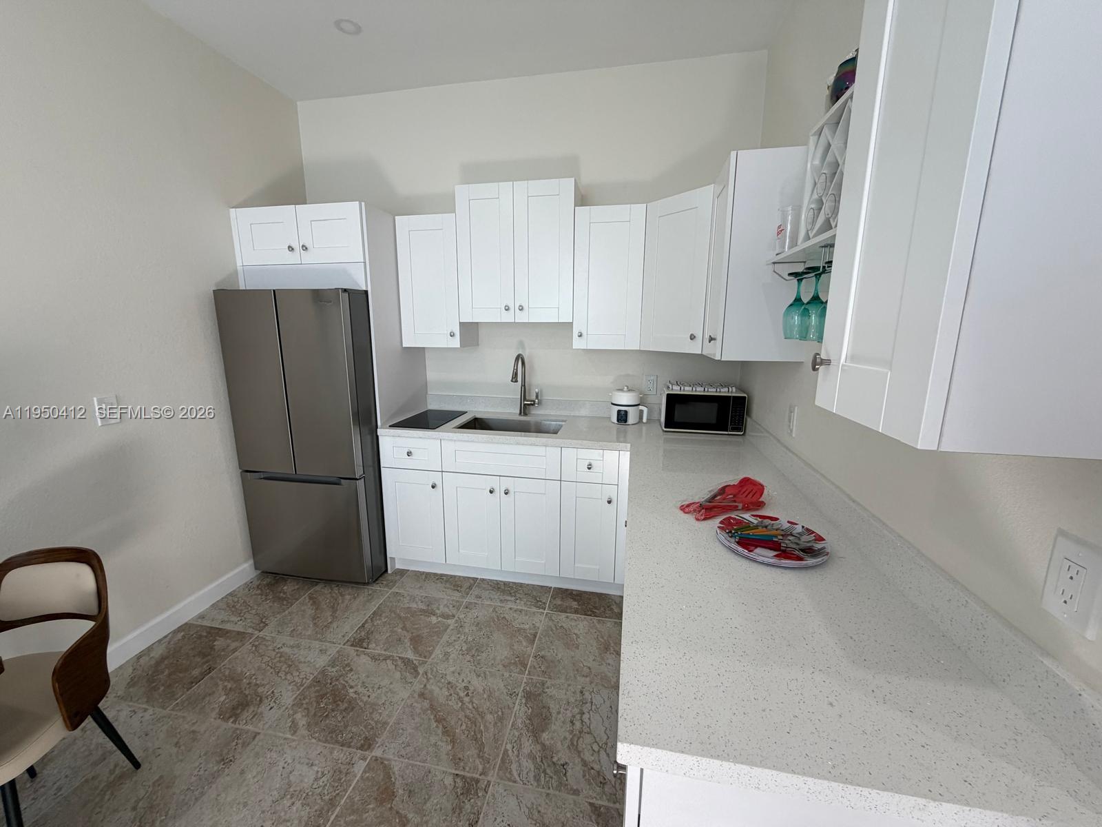 27264 Southwest 132nd Place, Unit A Homestead, FL 33032 - Photo 2 of 10 a kitchen with stainless steel appliances a refrigerator sink and cabinets