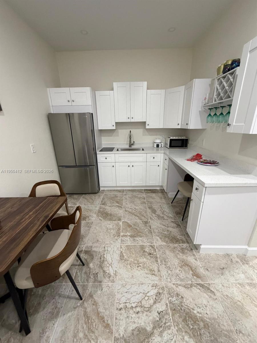 27264 Southwest 132nd Place, Unit A Homestead, FL 33032 - Photo 3 of 10 a room with a couch and a window