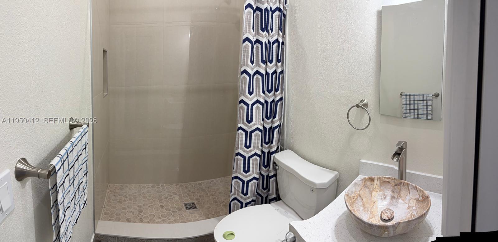 27264 Southwest 132nd Place, Unit A Homestead, FL 33032 - Photo 5 of 10 a bathroom with a toilet and shower