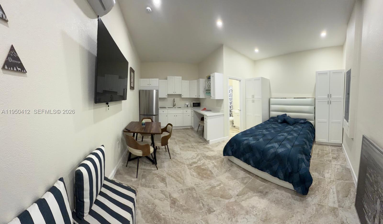 27264 Southwest 132nd Place, Unit A Homestead, FL 33032 - Photo 6 of 10 a living room with furniture and a flat screen tv
