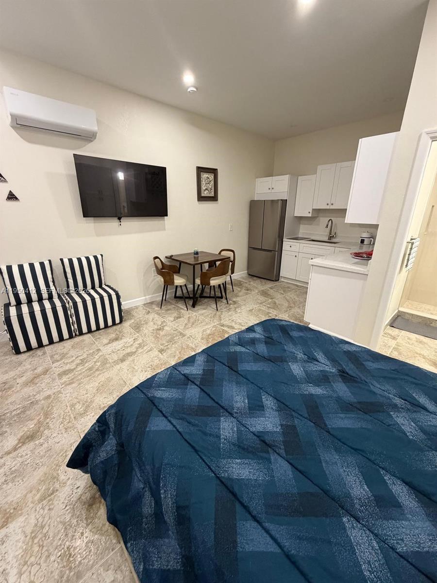 27264 Southwest 132nd Place, Unit A Homestead, FL 33032 - Photo 10 of 10 a living room with furniture and a flat screen tv