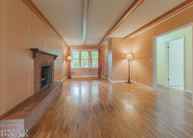 14016 Dry Grove Road Bloomington, IL 61705 - Photo 3 of 43 a view of an empty room with wooden floor and a window