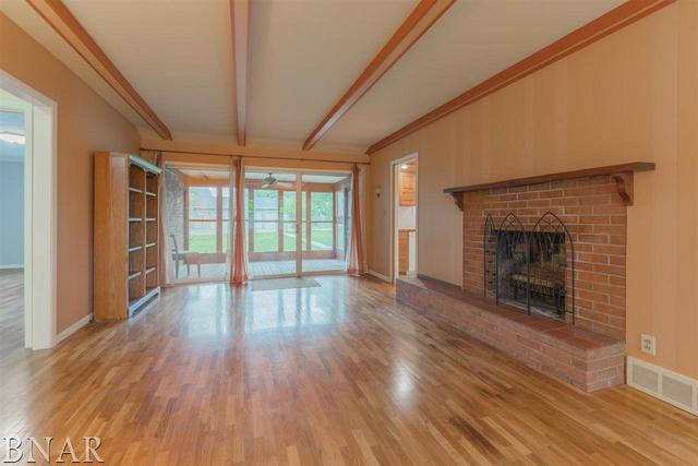 14016 Dry Grove Road Bloomington, IL 61705 - Photo 4 of 43 wooden floor fireplace and windows in an empty room