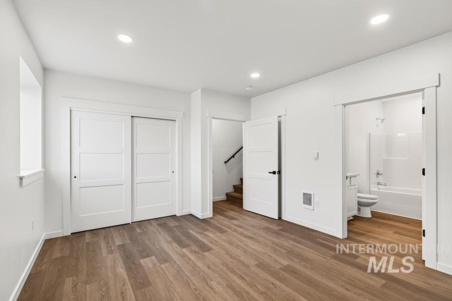 1298 Edington Moscow, ID 83843 - Photo 19 of 32 Recessed lighting, wood-finish flooring, white sliding closet doors, and white paneled interior doors