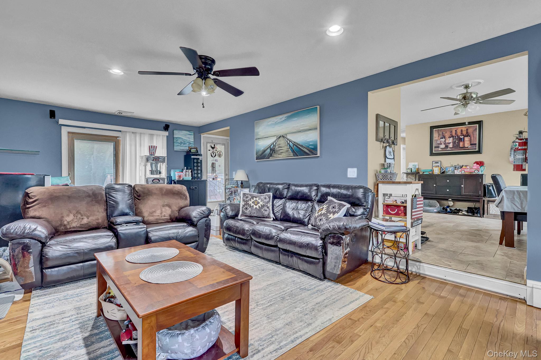 98 Granny Road Farmingville, NY 11738 - Photo 10 of 24 a living room with furniture and a wooden floor