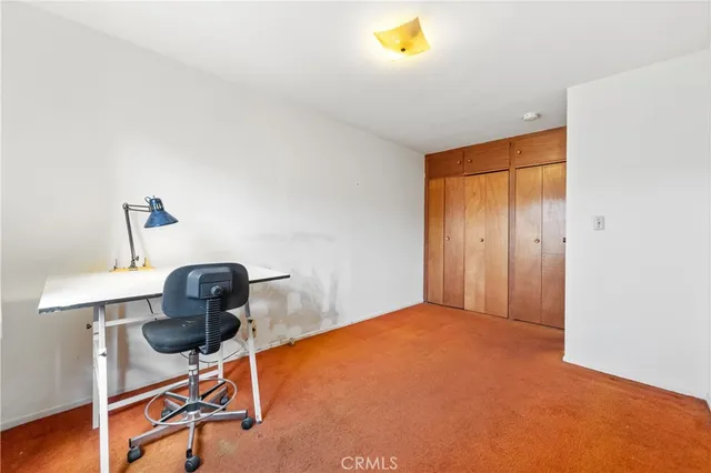 a view of a backyard with plants and a bench