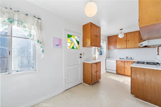 a room with cabinets a sink and a window
