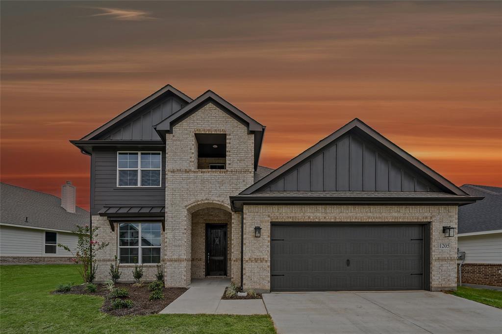 1205 Colca Drive Springtown, TX 76082 - Photo 1 of 37 Stone and siding exterior with a dark-paneled garage door